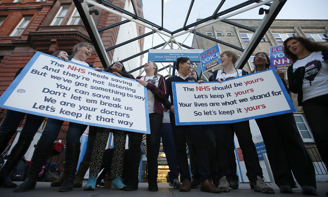 The British National Heath Service Singers who are either doctors or nurses perform a protest song in support of junior doctors outside Great Ormond Street Hospital for Sick Children as a 24 hour junior doctor strike starts in London Tuesday Jan. 12