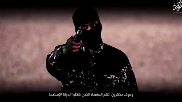 U.K. officials believe they've identified masked ISIS militant in video story image