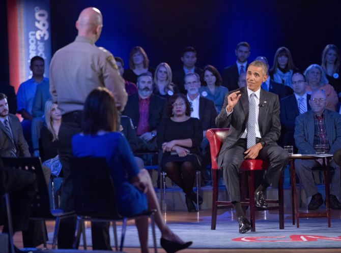 President Barack Obama answers Arizona Sheriff Paul Babeu left. At the CNN town hall meeting Thursday he asked firearm owners to support tougher laws that target criminals