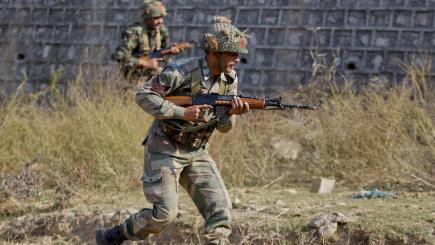 Indian soldiers search a forest area outside Pathankot air force base