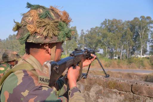 Indian army soldiers take up position on the perimeter of the airforce base in Pathankot