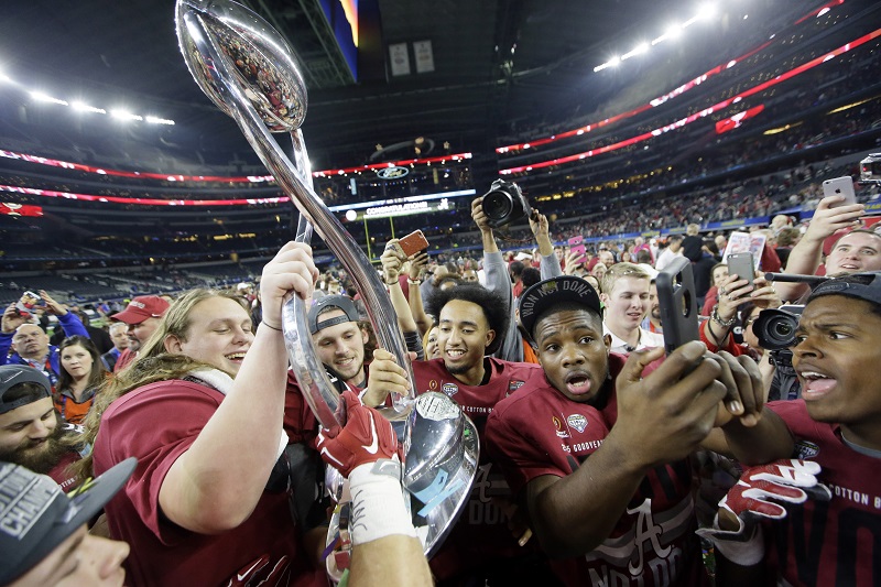 The Alabama team celebrates after the Cotton Bowl NCAA college football semifinal playoff game against Michigan State Thursday Dec. 31 2015 in Arlington Texas. Alabama won 38-0 to advance to the championship game