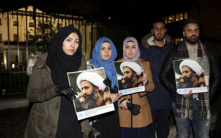 Protesters hold placards as they demonstrate against the execution of prominent Shi'ite cleric Sheikh Nimr al Nimr outside the Saudi Arabian Embassy in London Britain