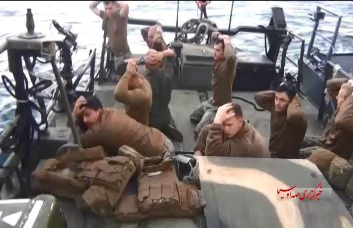 A handout TV grab made available by the official website of Iranian state television on 13 January 2016 shows American military personnel on their boat after they were captured by the Iranian Revolutionary Guard Corps, at an undisclosed loca