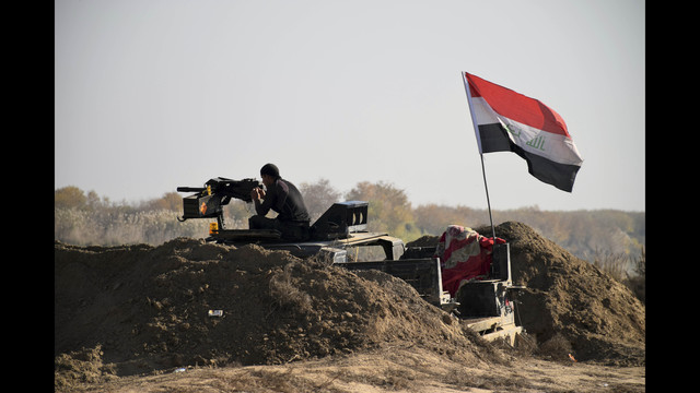 Iraqi Security forces with national flag enter downtown Ramadi 70 miles west of Baghdad Iraq Sunday Dec. 27 2015