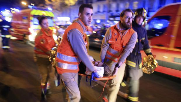 A victim is assisted after the Paris attacks