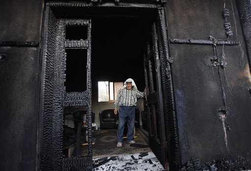 Palestinian inspects a house after it was torched in a suspected attack by Jewish settlers killing an 18-month-old Palestinian child and his parents at Duma village near the West Bank city of Nablus. Israel on Sunday