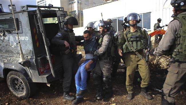 Israeli forces nab a Palestinian during clashes outside the West Bank city of Ramallah