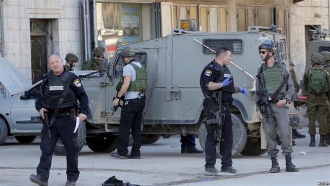 Israeli forces stand guard near the scene where two Palestinians were shot dead in the village of Huwara near Nablus Dec. 27 2015