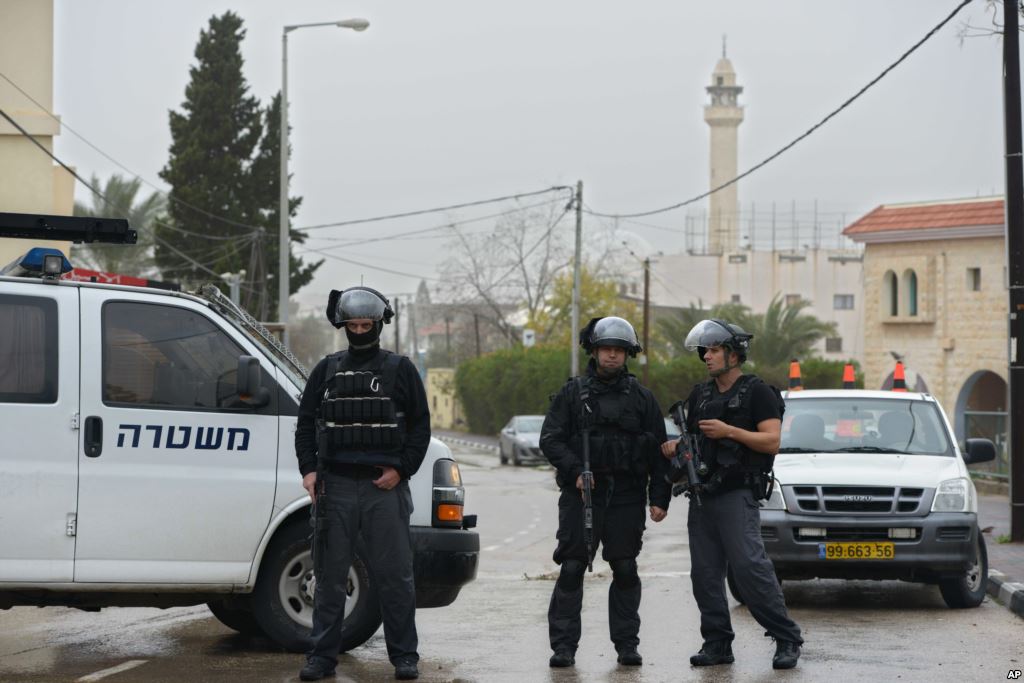 Israeli policemen stand on guard in the village of Arara northern Israel Jan. 8 2016