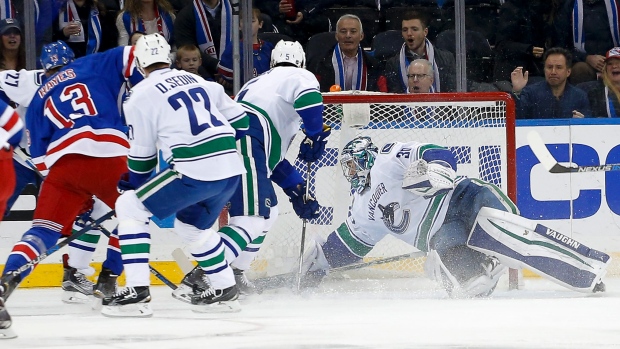 Vancouver Canucks goalie Ryan Miller blocks a shot by the New York Rangers during the first period on Tuesday Jan. 19 2016 in New York