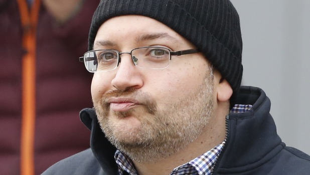 Jason Rezaian grimaces as he poses for media people in front of Landstuhl Regional Medical Centre in Landstuhl Germany