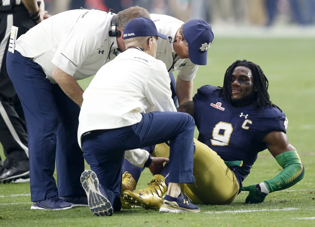 Notre Dame linebacker Jaylon Smith is attended to after being injured against Ohio State during the first half of the Fiesta Bowl NCAA College football game Friday Jan. 1 2016 in Glendale Ariz