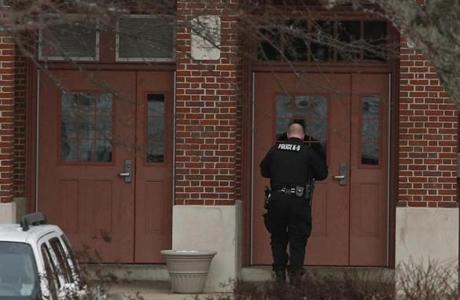 Arlington Massachusetts- 1/19/2016 An Arlington Police officer enters Arlington High School after a bomb threat was called in and the students sent home in Arlington Massachusetts