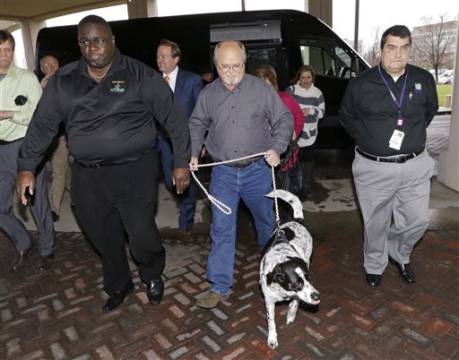 John Robinson center of Munford Tenn. arrives with his dog at the Tennessee Lottery headquarters Friday Jan. 15 2016 in Nashville Tenn. Robinson claims to have one of the winning tickets in the record $1.6 billion jackpot drawing that took place