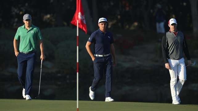 Jordan Spieth and Rickie Fowler on the 12th green with Rory McIlroy