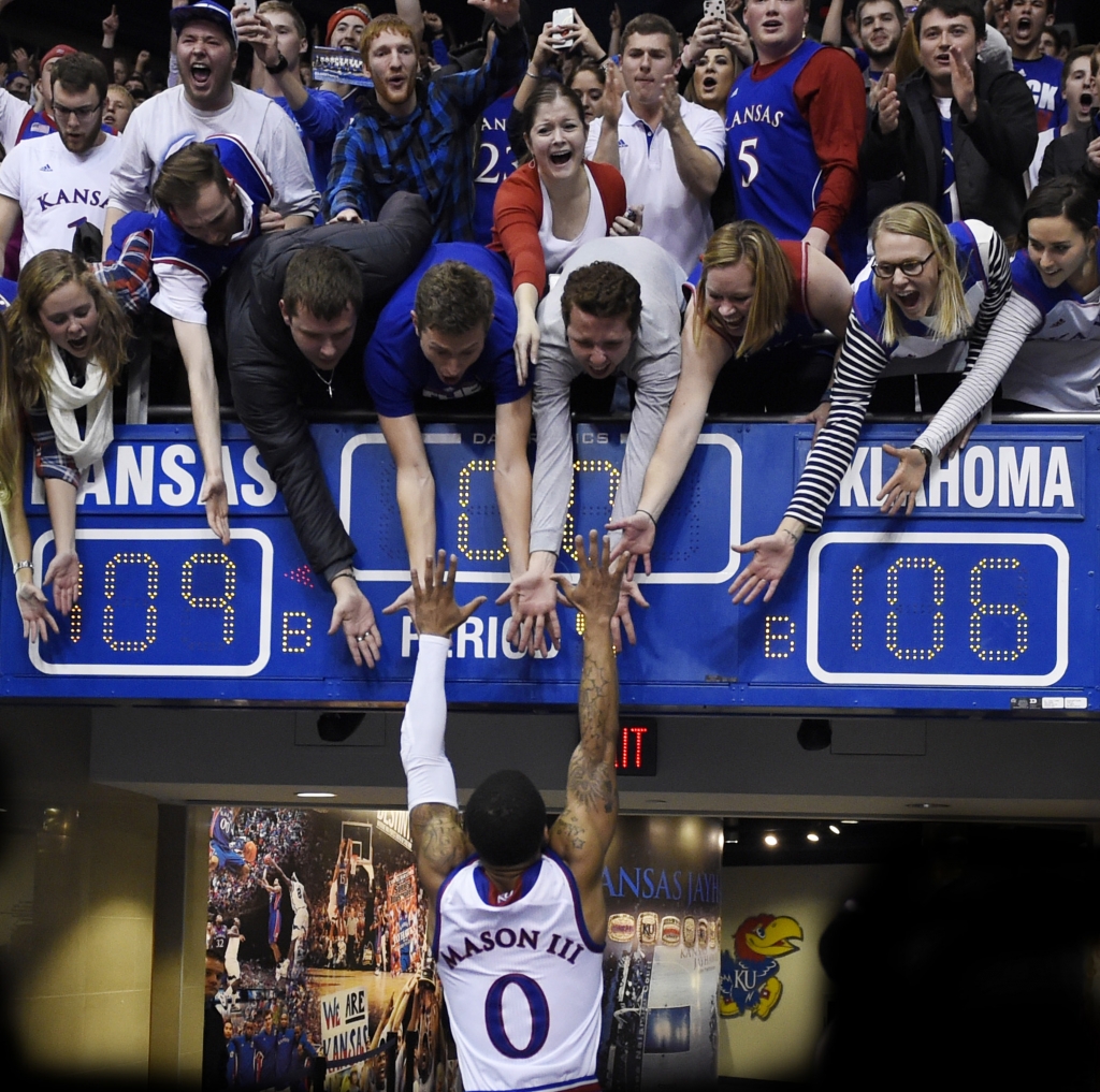 KU's Frank Mason jumps into the arms of his classmates after the Jayhawks beat Oklahoma 109-106 in triple overtime Monday night Jan. 4 2016 at Allen Fieldhouse in Lawrence Kan