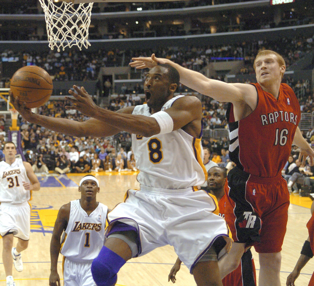 Toronto Raptors Matt Bonner can't stop Los Angeles Lakers Kobe Bryant from getting to the basket in the first hal