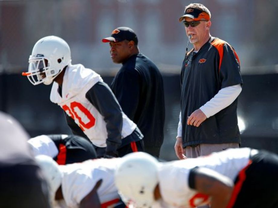 Oklahoma State defensive coordinator Glenn Spencer right watches his team's spring practice in Stillwater Okla. on March 13