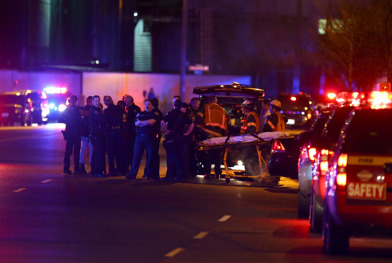 Law enforcement and medics respond to a shooting near Airport Way South and Atlantic Street on Tuesday night in Seattle