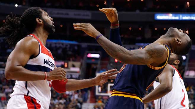 Cleveland Cavaliers forward Le Bron James right reacts after being hit in the face by Washington Wizards center Nene left from Brazil during the first half of an NBA basketball game Wednesday Jan. 6 2016 in Washington. James remained in the game