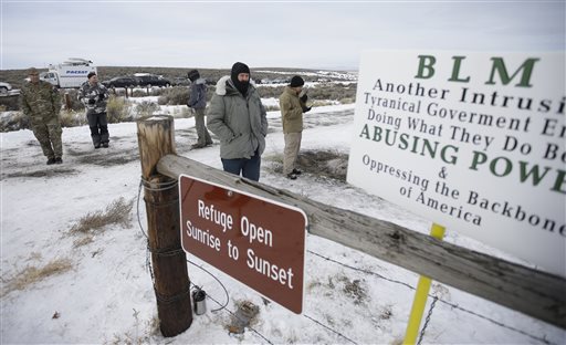 Members of the group occupying the Malheur National Wildlife Refuge headquarters stand guard Monday Jan. 4 2016 near Burns Ore. The group calls itself Citizens for Constitutional Freedom and has sent a'demand for redress to local state and federal