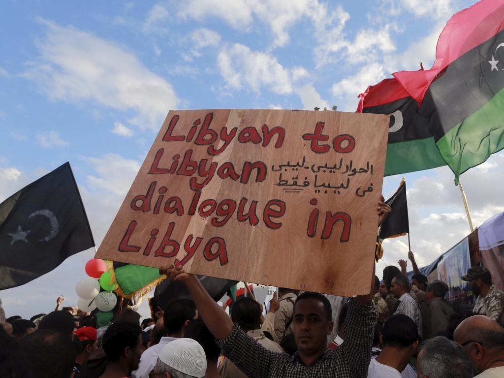 A man holds a sign during a protest against candidates for a national unity government proposed by U.N. envoy for Libya Bernardino Leon in Benghazi Libya