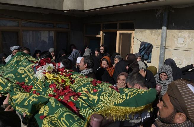 Afghan relatives react during the funeral for Saeed Jawad Hossini 29 who was killed in a suicide attack on a minibus carrying employees of Afghan TV channel TOLO in Kabul