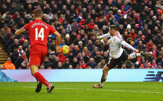 Wayne Rooney of Manchester United scores the opening goal during the Barclays Premier League match between Liverpool and Manchester United at Anfield