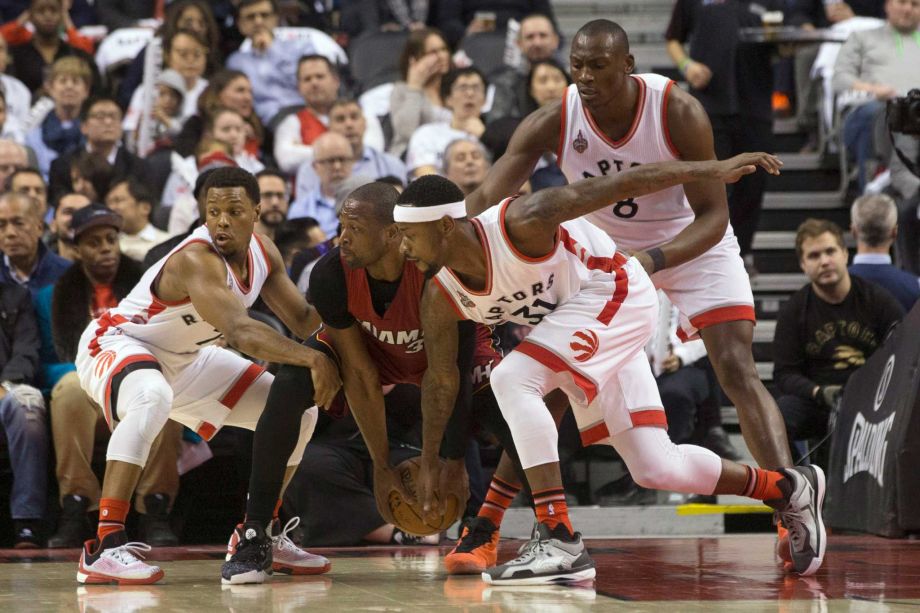 Miami Heat's Dwyane Wade second from left gathers the ball under pressure from Toronto Raptors Kyle Lowry left Terrence Ross and Bismack Biyombo during the first half of an NBA basketball game Friday Jan. 22 2016 in Toronto. (Chris Young