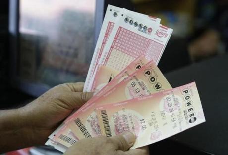 A customer held his Powerball tickets Saturday in Miami