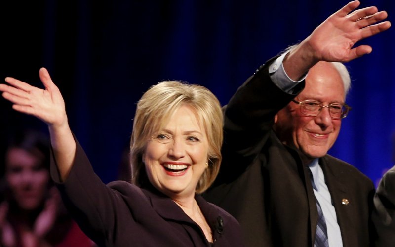 Democratic presidential candidates Hillary Clinton and Bernie Sanders wave following the First in the South Presidential Candidates Forum held at Winthrop University in Rock Hill South Carolina