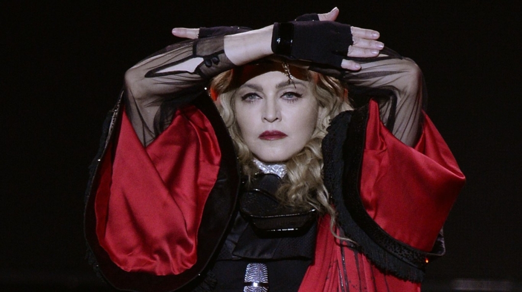 Madonna throws herself to the ground as she pays tribute to David Bowie