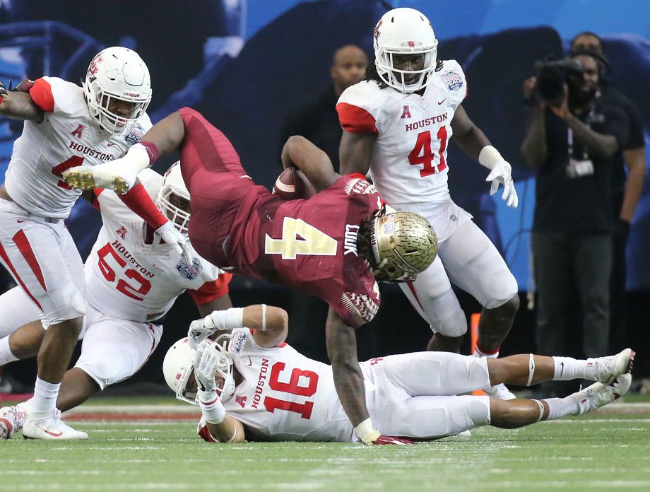 Houston defenders cut down Florida State running back Dalvin Cook for a short gain during the second half of the Peach Bowl NCAA college football game Thursday Dec. 31 2015 in Atlanta.  MARIETTA DAI