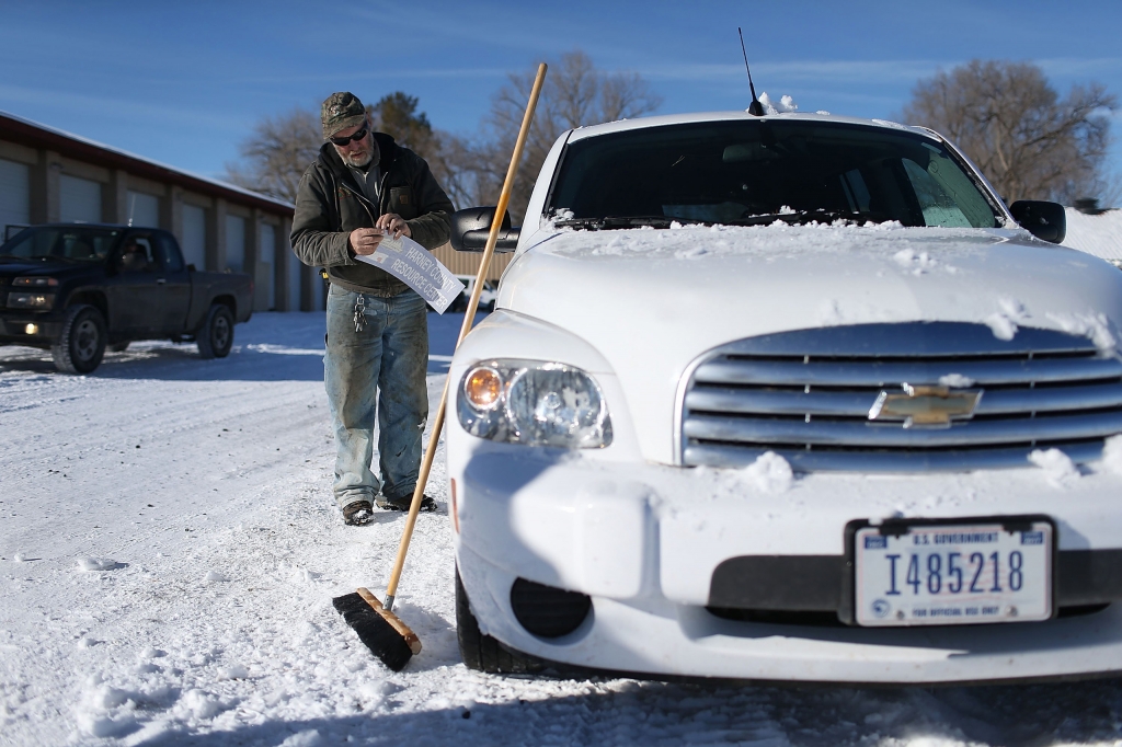 BURNS OR- JANUARY 15 Ken Medenbach prepares to paste a Harney County sticker on the side of a U.S. Government vehicle as a group continues to occupy the Malheur National Wildlife Refuge headquarters