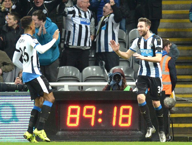 Newcastle United's Welsh defender Paul Dummett celebrates with Newcastle United's English striker Ivan Toney after scoring Newcastle's third goal during the English Premier League football match between Newcastle United and Manchester United at St