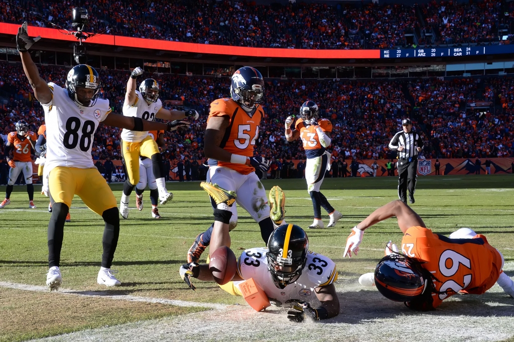 20160117pdSteelersSports05 Fitzgerald Toussaint is downed at the 1-yard line after a 15-yard run in the first quarter Sunday in Denver. Toussaint scored on the next play