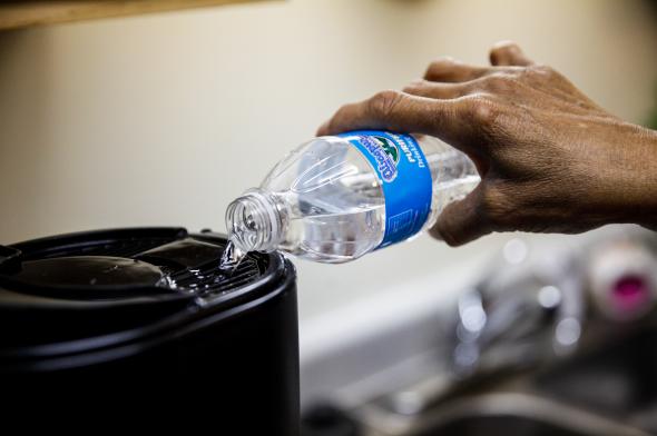 506096360-mary-stewart-pours-bottled-water-to-make-coffee-in-her