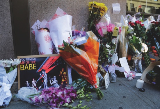 Memorabilia and bouquets of flowers are left in honor of David Bowie outside his New York apartment