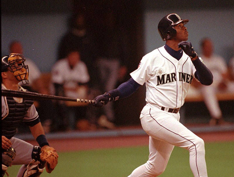 Seattle Mariners Ken Griffey Jr. and New York Yankees catcher Joe Girardi watch the flight of Griffey's first-inning home run Tuesday