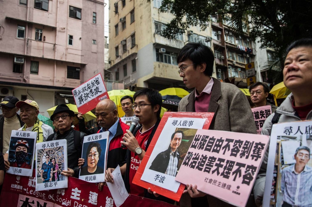 Image Protesters hold up missing person notices