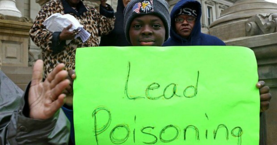 Montae Terry 12 holds a sign during a protest at the State Capitol in Lansing Wednesday