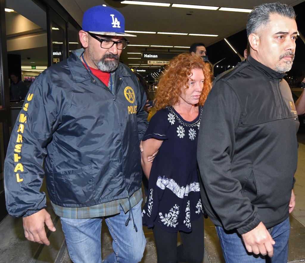 Tonya Couch center is taken by authorities after arriving at Los Angeles International Airport Thursday Dec. 31 2015 in Los Angeles. Authorities said she and her son Texas teenager Ethan Couch who was sentenced to probation after using an'affluen