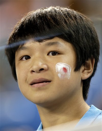 A fan of Japan's Kei Nishikori waits for his second round match against Austin Krajicek of the United States to begin at the Australian Open tennis championships in Melbourne Australia Wednesday Jan. 20 2016