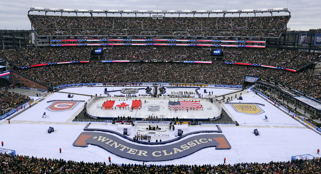 The Canadian and American flags are presented during the national anthems prior the NHL Winter Classic hockey game between the Boston Bruins and Montreal Can