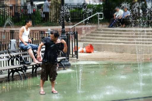 A man cools off at a water fountain in New York in 2015 where the month of May was recorded as the hottest in modern history