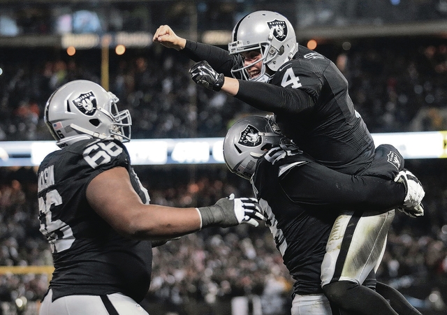 ASSOCIATED PRESS           Oakland Raiders quarterback Derek Carr top celebrates with guard Gabe Jackson left and offensive guard Jon Feliciano after the Raiders scored against the San Diego Chargers during the second half of