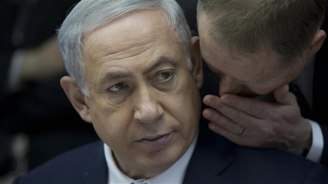 Israeli Prime Minister Benjamin Netanyahu listens to his spokesman Boaz Stambler as he leads a weekly cabinet meeting at his office in al Quds