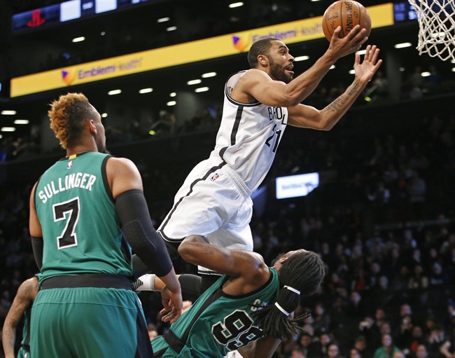 Brooklyn Nets guard Wayne Ellington sends Boston Celtics forward Jae Crowder flying to the floor in the first half of an NBA basketball game Monday Jan. 4 2016 in New York