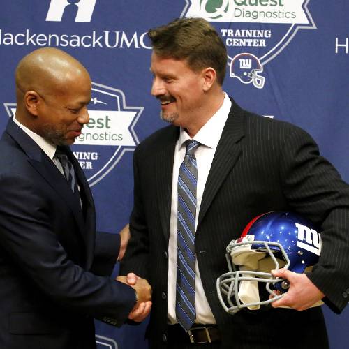 Giants general manager Jerry Reese left shakes hands with former offensive coordinator Ben Mc Adoo talks during a news conference announcing Mc Adoo as the new head coach of the NFL football team Friday Jan. 15 2016 in East Rutherford